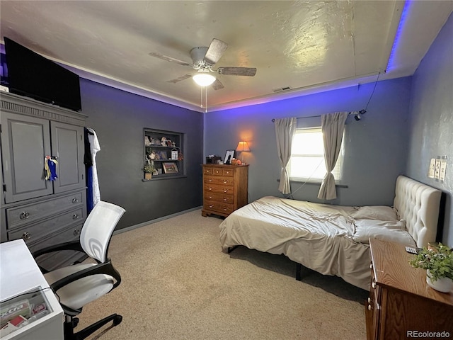 carpeted bedroom featuring ceiling fan and visible vents
