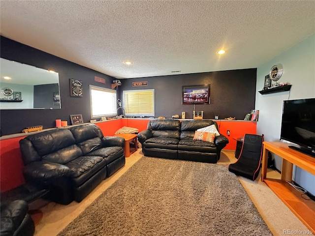 living area featuring carpet floors, recessed lighting, and a textured ceiling