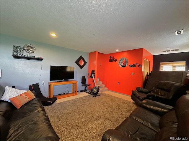 carpeted living room featuring recessed lighting, a textured ceiling, and visible vents