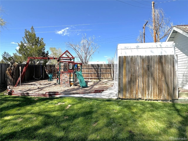 view of jungle gym featuring a lawn and a fenced backyard