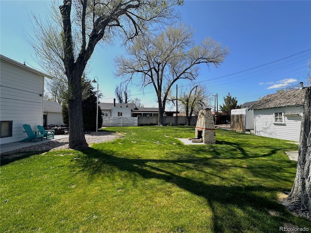 view of yard featuring fence and a patio