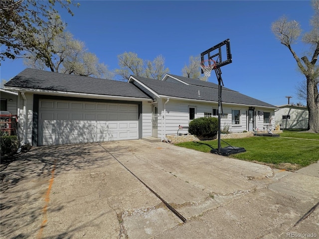 view of front of home with concrete driveway, a front lawn, and a garage