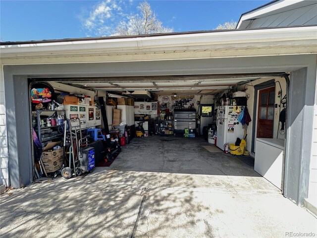 329 6th St, Hugo, CO 80821 - garage with freestanding refrigerator and driveway