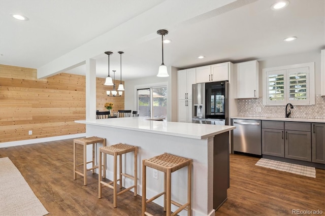8242 E Briarwood Pl, Centennial, CO 80112 - kitchen with appliances with stainless steel finishes, a sink, dark wood-style flooring, plenty of natural light, and recessed lighting