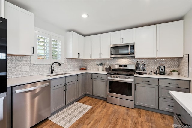 8242 E Briarwood Pl, Centennial, CO 80112 - kitchen featuring appliances with stainless steel finishes, a sink, gray cabinets, light countertops, and recessed lighting