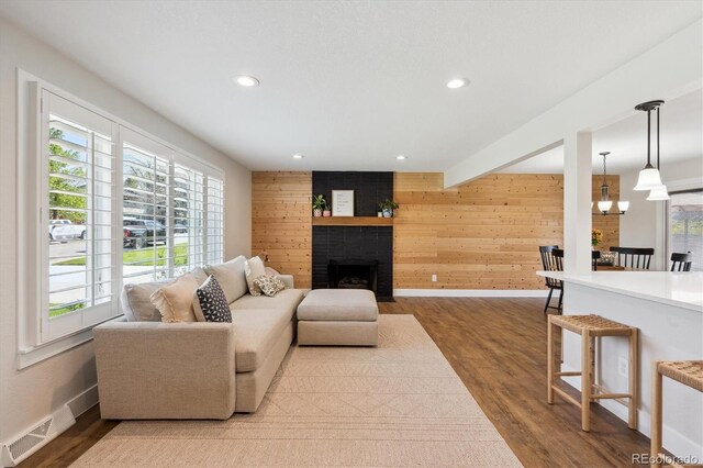 8242 E Briarwood Pl, Centennial, CO 80112 - living area with plenty of natural light, baseboards, recessed lighting, wooden walls, and a fireplace