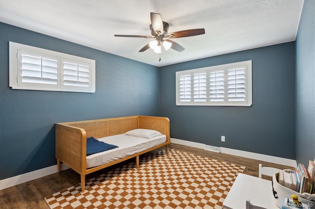 8242 E Briarwood Pl, Centennial, CO 80112 - bedroom featuring wood finished floors, baseboards, and ceiling fan