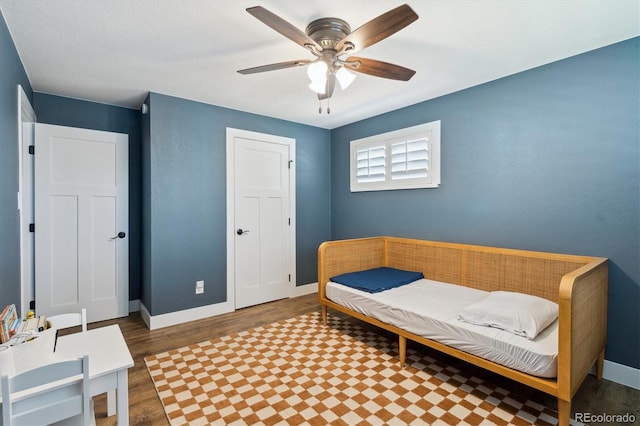 8242 E Briarwood Pl, Centennial, CO 80112 - bedroom with wood finished floors, baseboards, and ceiling fan