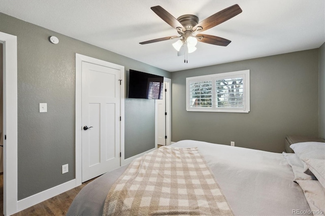 8242 E Briarwood Pl, Centennial, CO 80112 - bedroom featuring wood finished floors, baseboards, and a ceiling fan