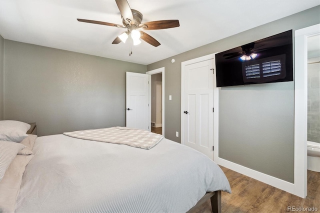 8242 E Briarwood Pl, Centennial, CO 80112 - bedroom with wood finished floors, baseboards, ceiling fan, and connected bathroom