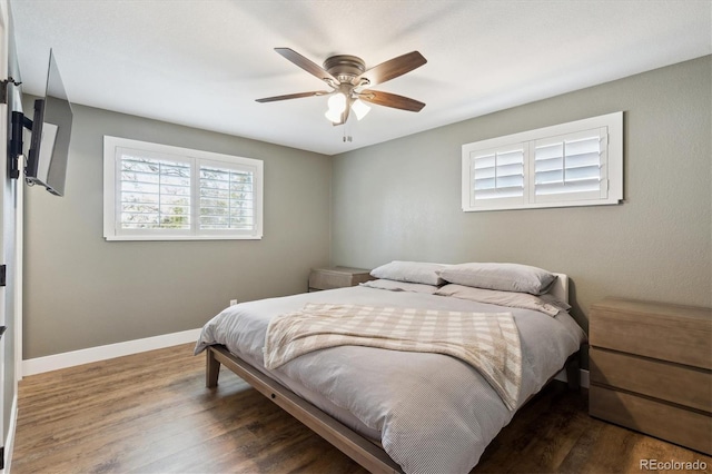8242 E Briarwood Pl, Centennial, CO 80112 - bedroom with wood finished floors, ceiling fan, and baseboards