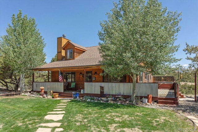 15700 County Road 352, Buena Vista, CO 81211 - rear view of house featuring a yard, a chimney, covered porch, and a jacuzzi