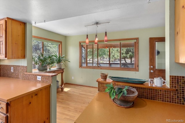 15700 County Road 352, Buena Vista, CO 81211 - kitchen with light wood-style flooring, tasteful backsplash, and pendant lighting