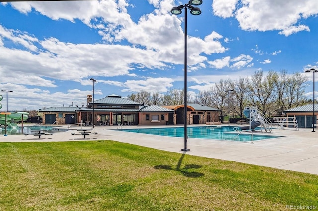 view of pool featuring a gazebo, a patio, a water slide, and a lawn