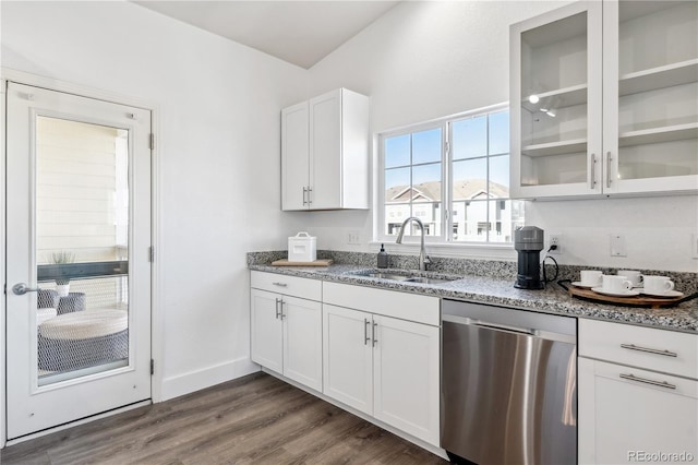 kitchen with sink, light stone counters, stainless steel dishwasher, dark hardwood / wood-style flooring, and white cabinets