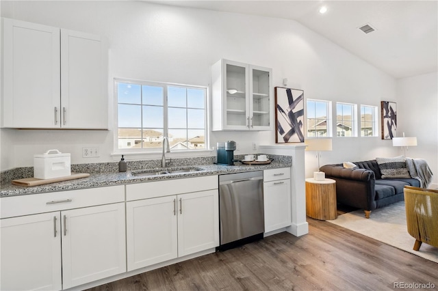 kitchen with white cabinetry, sink, light stone countertops, and dishwasher