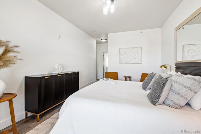 bedroom with dark hardwood / wood-style floors