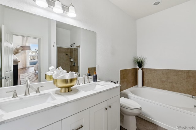 full bathroom featuring hardwood / wood-style flooring, vanity, toilet, and plus walk in shower