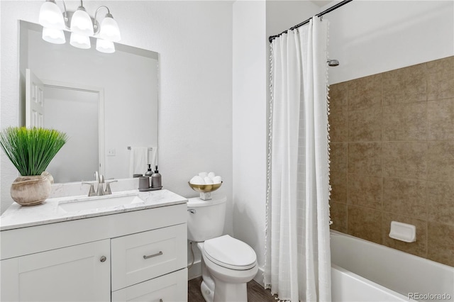 full bathroom featuring vanity, shower / tub combo, an inviting chandelier, and toilet