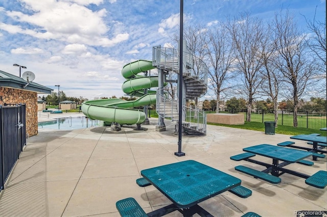 view of community with a playground and a patio