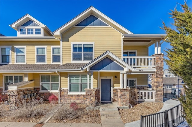 9471 Ashbury Cir Unit 202, Parker, CO 80134 - view of front of property featuring a balcony, stone siding, covered porch, and a shingled roof