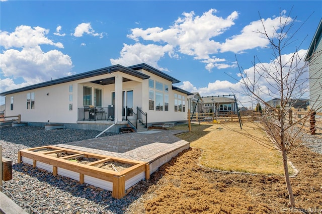 back of property featuring a garden, a yard, and a patio area