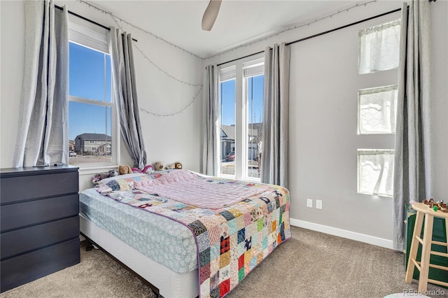 bedroom with baseboards, a ceiling fan, and carpet floors