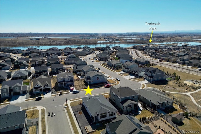 drone / aerial view with a water view and a residential view