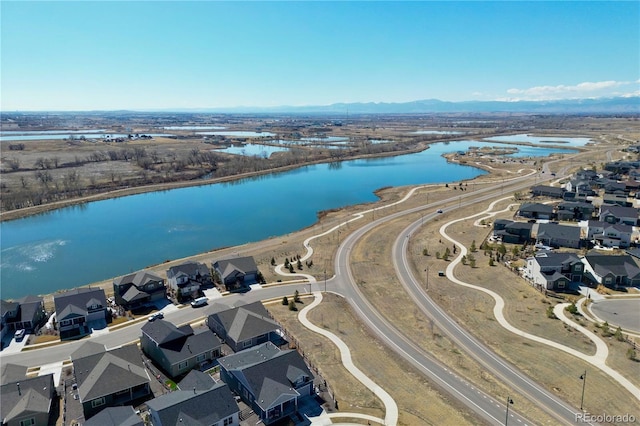 birds eye view of property featuring a water and mountain view and a residential view