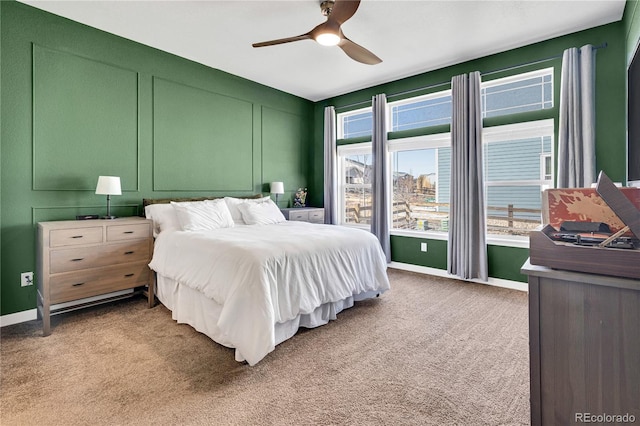 bedroom with light colored carpet, baseboards, and ceiling fan