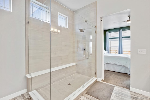 bathroom with a stall shower, baseboards, ensuite bath, and wood finished floors
