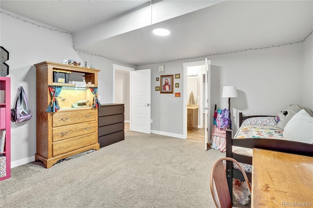 bedroom featuring ensuite bathroom, carpet flooring, and baseboards