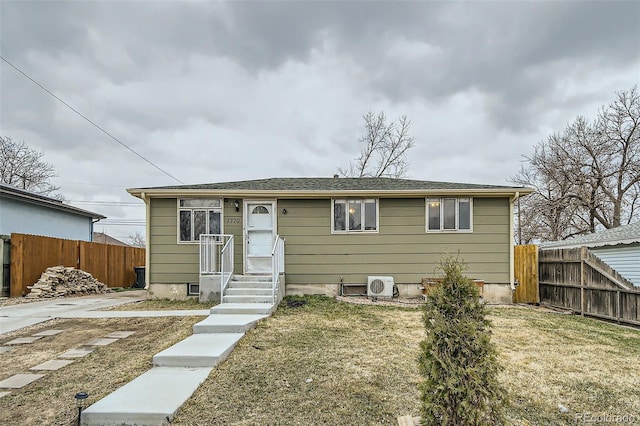 bungalow-style house with ac unit, a front yard, and fence