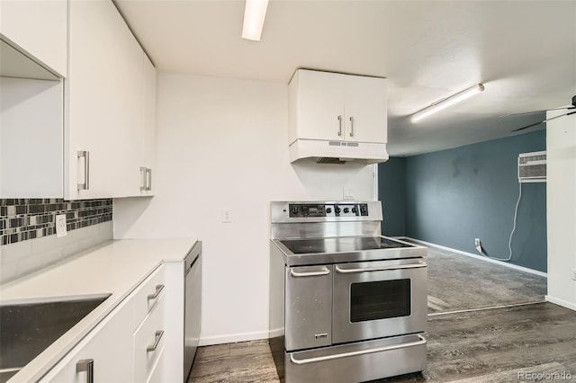 kitchen featuring under cabinet range hood, tasteful backsplash, dark wood-style floors, appliances with stainless steel finishes, and white cabinets