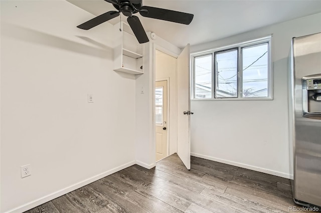 unfurnished room featuring ceiling fan, baseboards, and wood finished floors