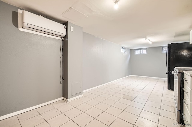 below grade area with light tile patterned floors, baseboards, and a wall unit AC