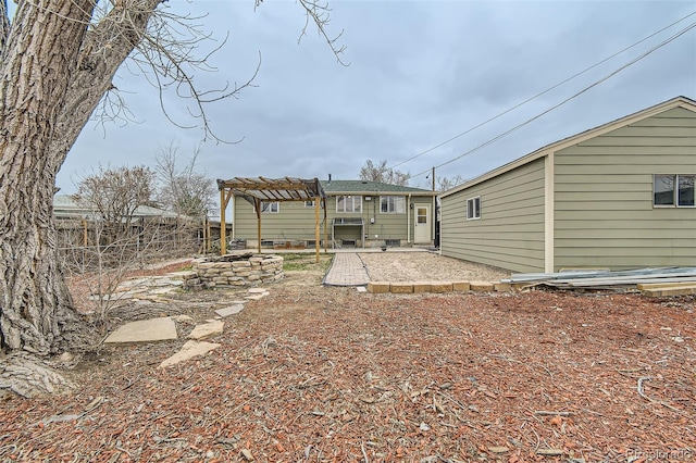 back of property featuring a patio area, a pergola, and fence