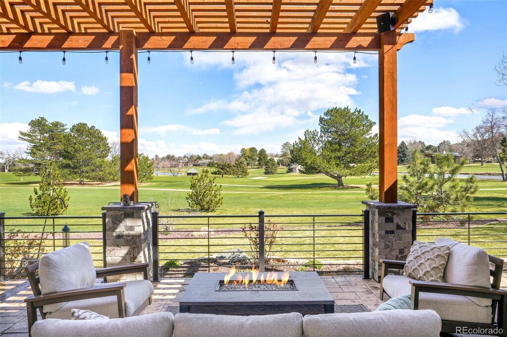 3930 S Pinehurst Cir, Denver, CO 80235 - view of patio / terrace with an outdoor living space with a fire pit, fence, golf course view, and a pergola