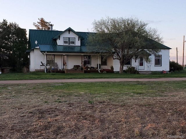 view of front of home with a yard and covered porch