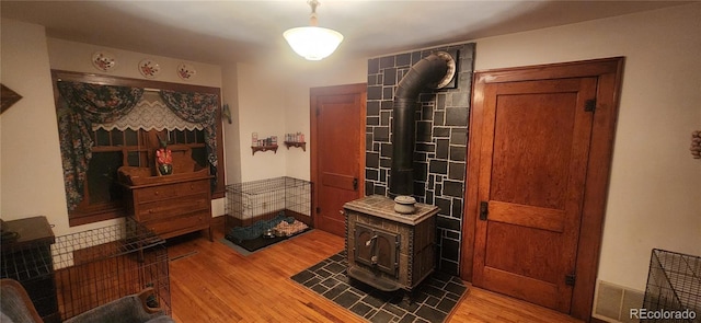 bathroom featuring a wood stove and hardwood / wood-style flooring