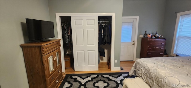 bedroom with light wood-type flooring and a closet