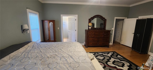 bedroom featuring crown molding and light hardwood / wood-style flooring