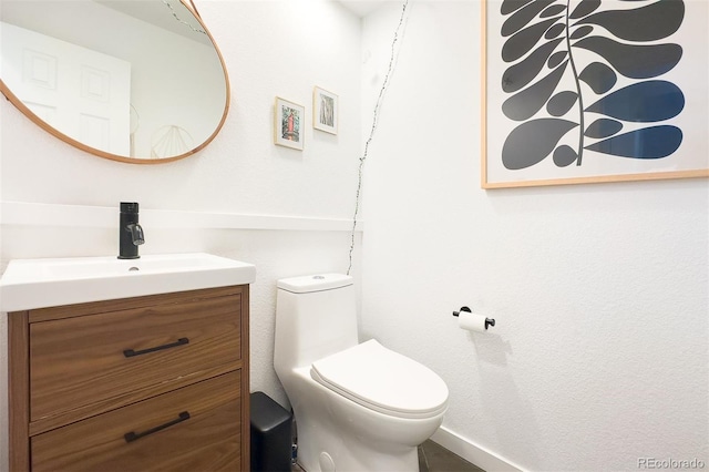 661 Snowberry St, Longmont, CO 80503 - bathroom featuring baseboards, toilet, and vanity
