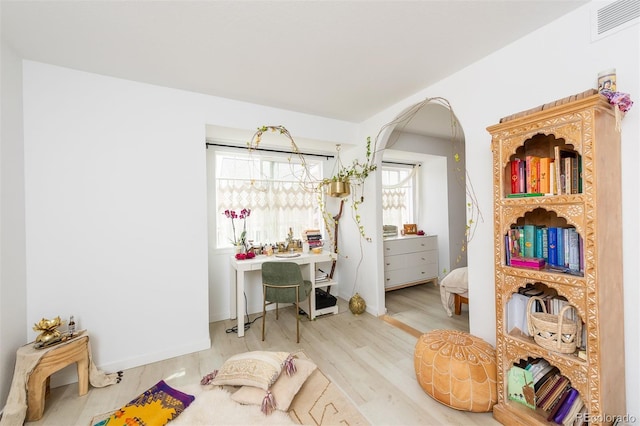 661 Snowberry St, Longmont, CO 80503 - bedroom with wood finished floors, visible vents, and arched walkways