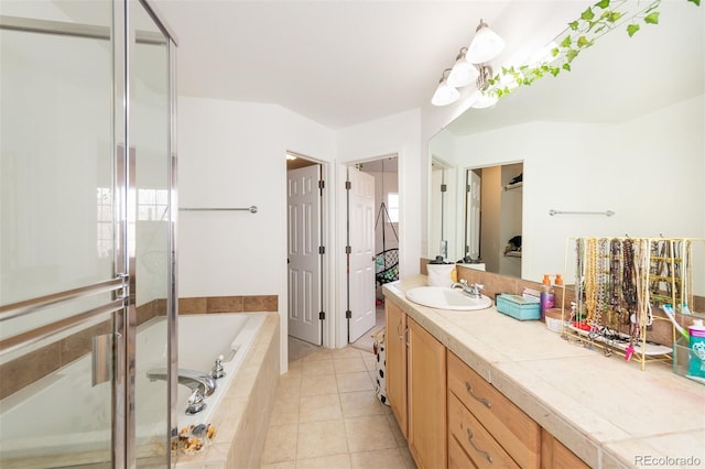 661 Snowberry St, Longmont, CO 80503 - full bathroom featuring a garden tub, vanity, tile patterned floors, and a stall shower