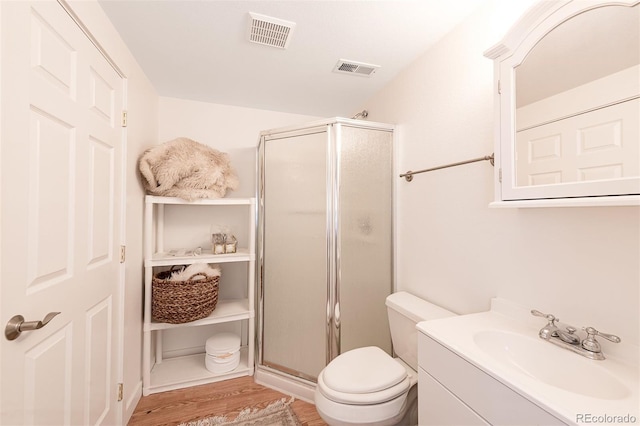 661 Snowberry St, Longmont, CO 80503 - bathroom with visible vents, vanity, wood finished floors, and a shower stall