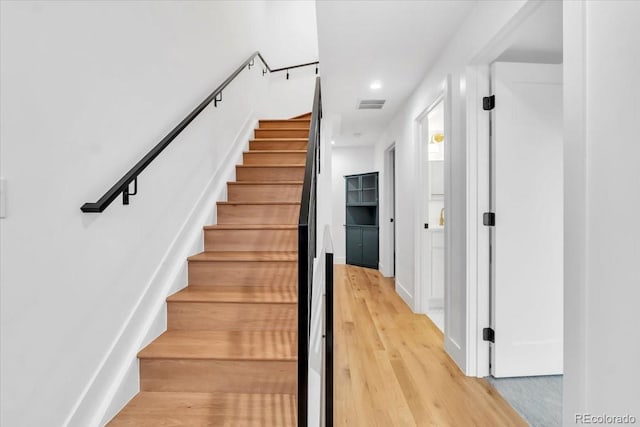 stairs featuring hardwood / wood-style flooring