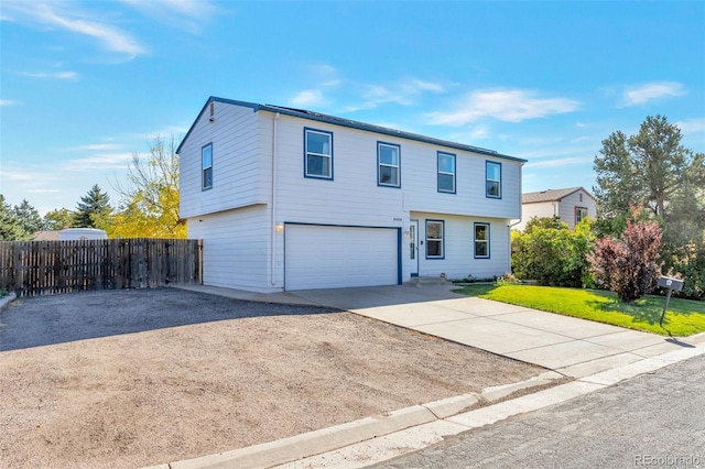 front facade featuring a front lawn and a garage