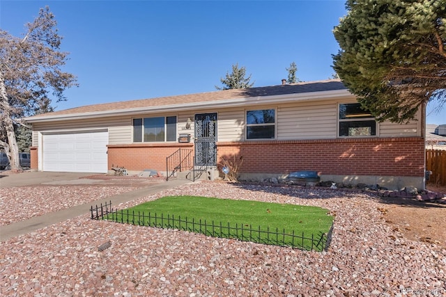 ranch-style home with brick siding, driveway, an attached garage, and fence