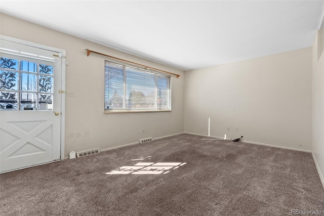 carpeted empty room with baseboards and visible vents